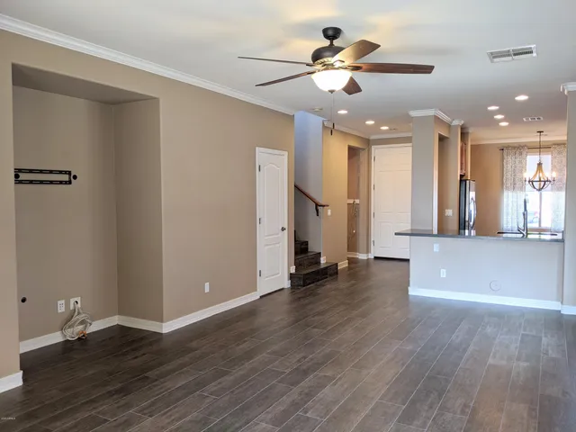 a view of an empty room and window with wooden floor