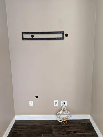 a view of wooden floor and windows in a room