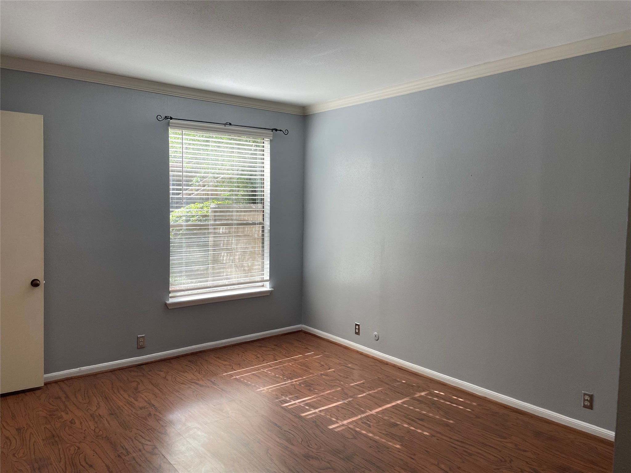 2829 Timmons Lane, Unit 215 Houston, TX 77027 - Photo 13 of 13 an empty room with wooden floor and window