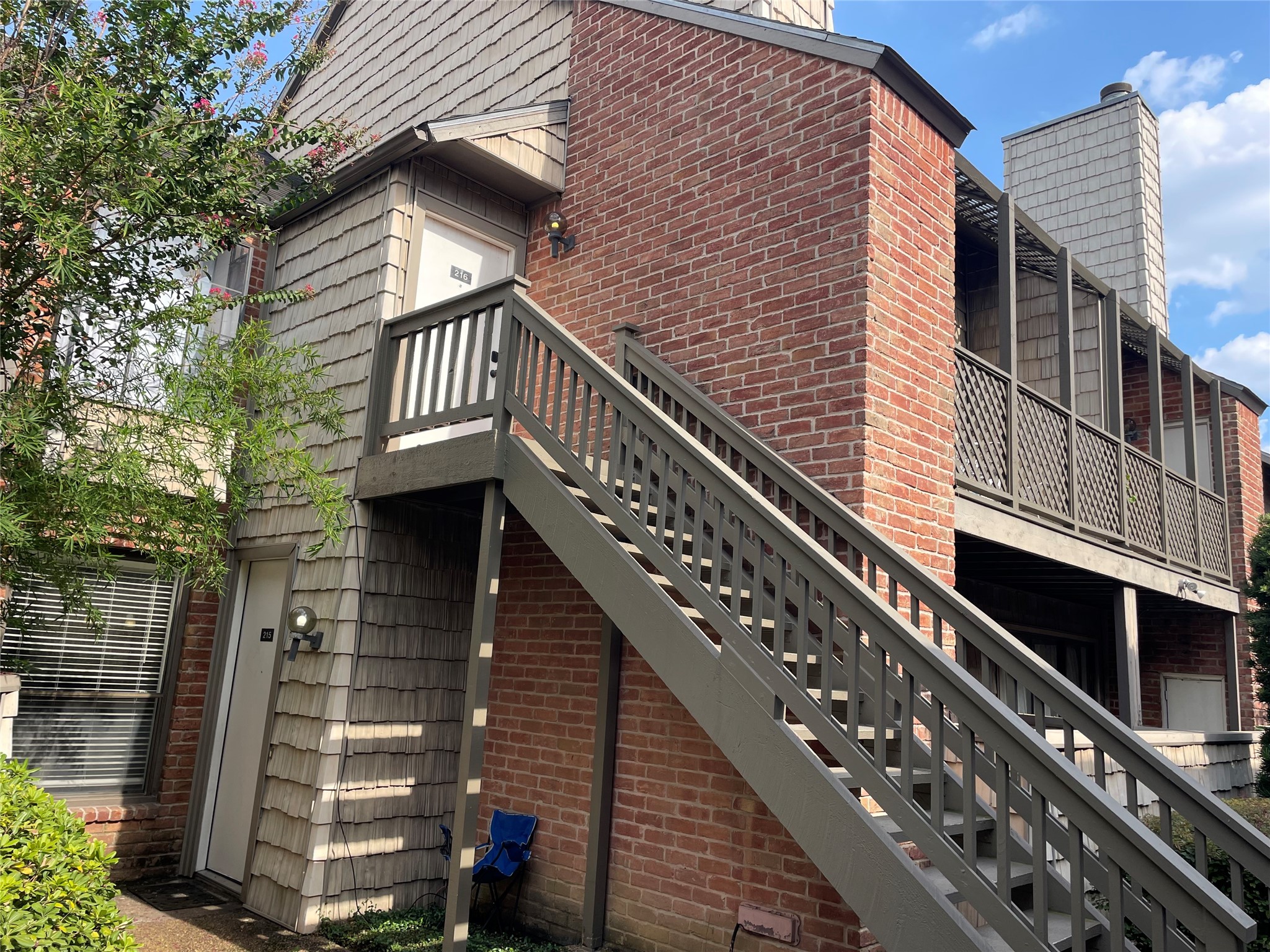 2829 Timmons Lane, Unit 215 Houston, TX 77027 - Photo 7 of 13 a view of a balcony with wooden stairs