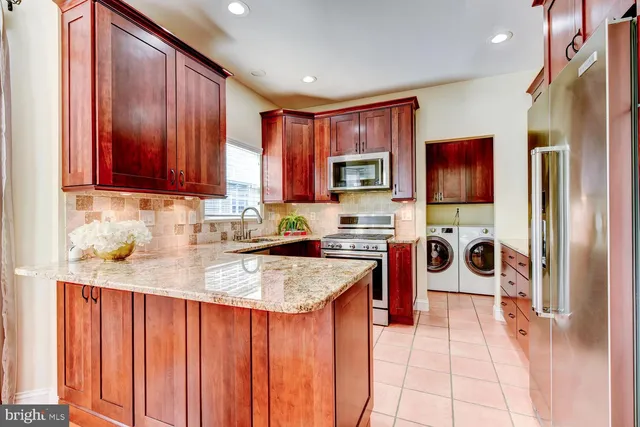 a kitchen with stainless steel appliances granite countertop a stove top oven a sink and dishwasher