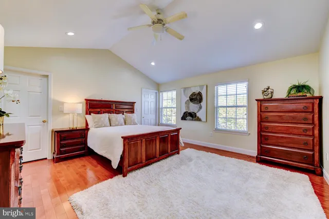 a spacious bedroom with a bed and a window