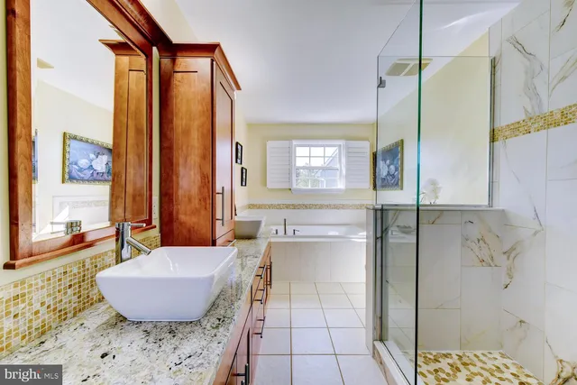 a bathroom with a tub shower and sink