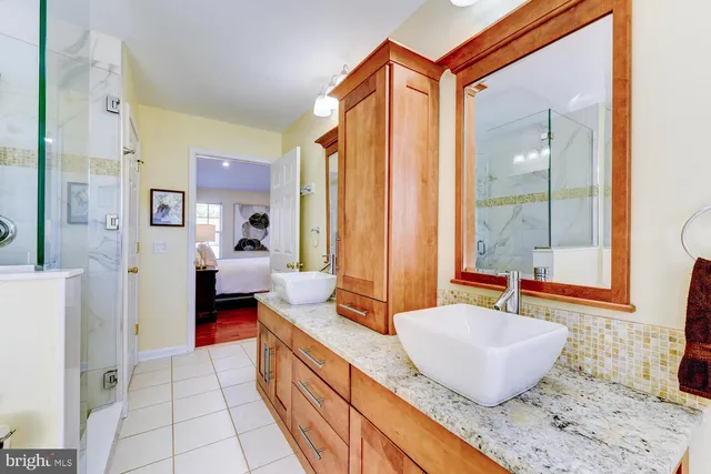 a large room with a couch and a potted plant