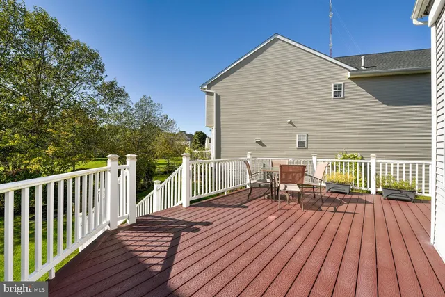 a view of a roof deck with wooden floor and fence