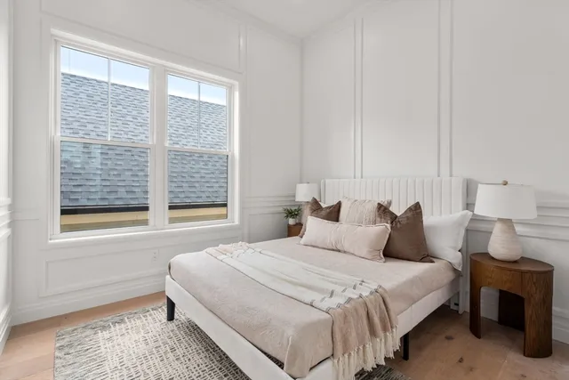 a bedroom with a bed and a window