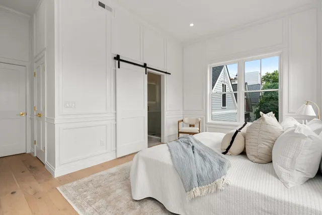 a bedroom with a large bed and a window