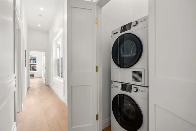 a view of a hallway with washer and dryer