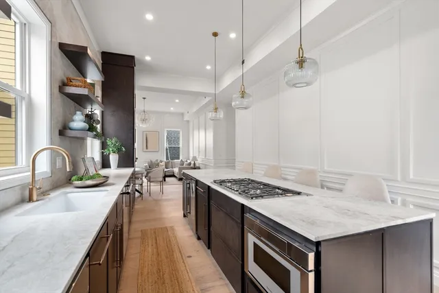 a kitchen with sink stove and cabinets