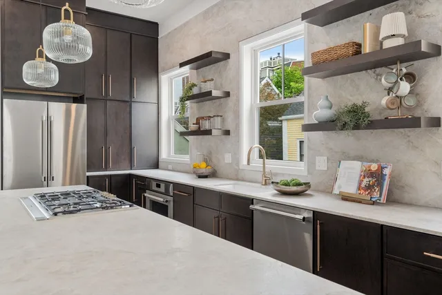 a kitchen with a sink cabinets and window