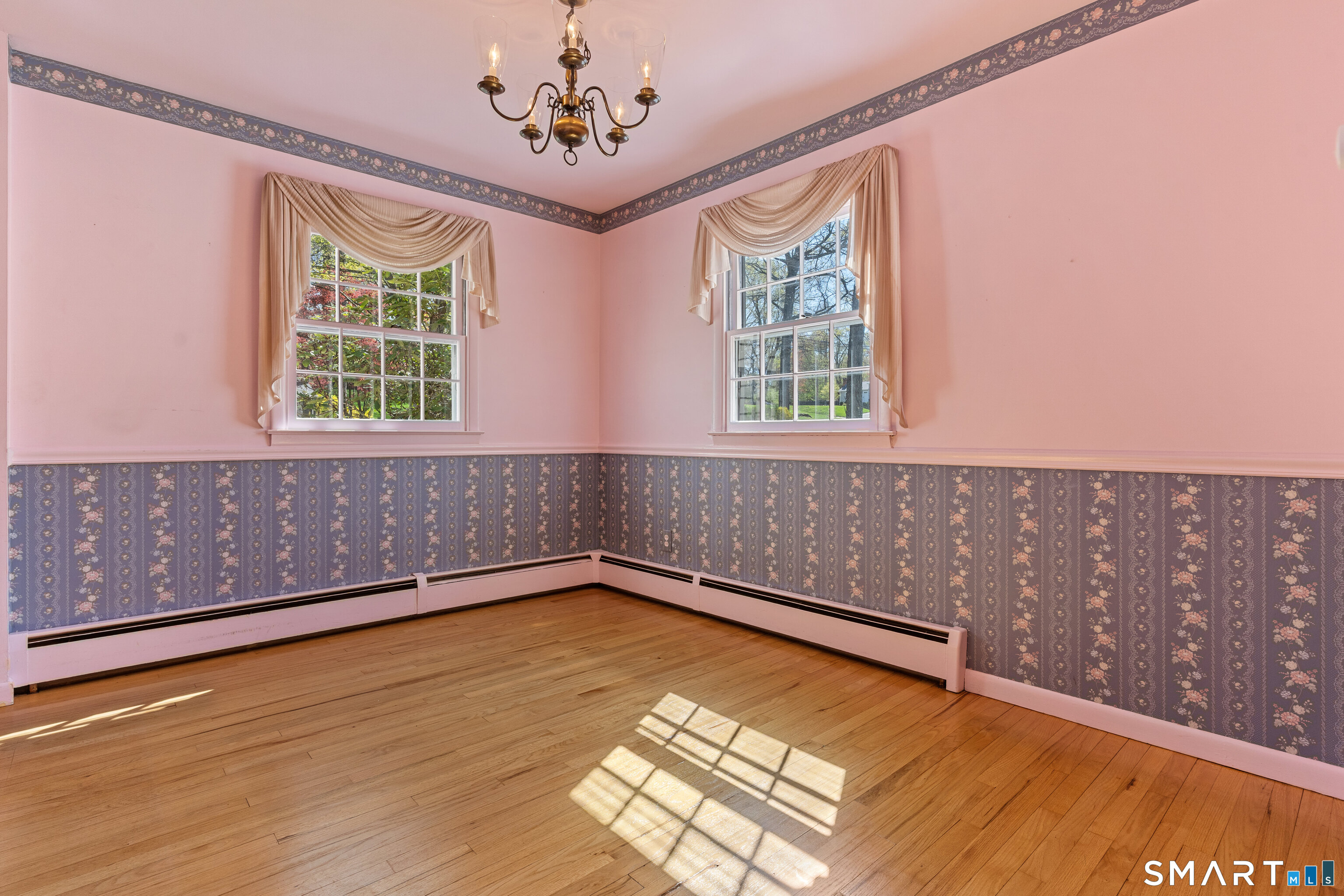 251 Shelter Rock Road Fairfield, CT 06825 - Photo 11 of 38 a view of an empty room with a window and wooden floor