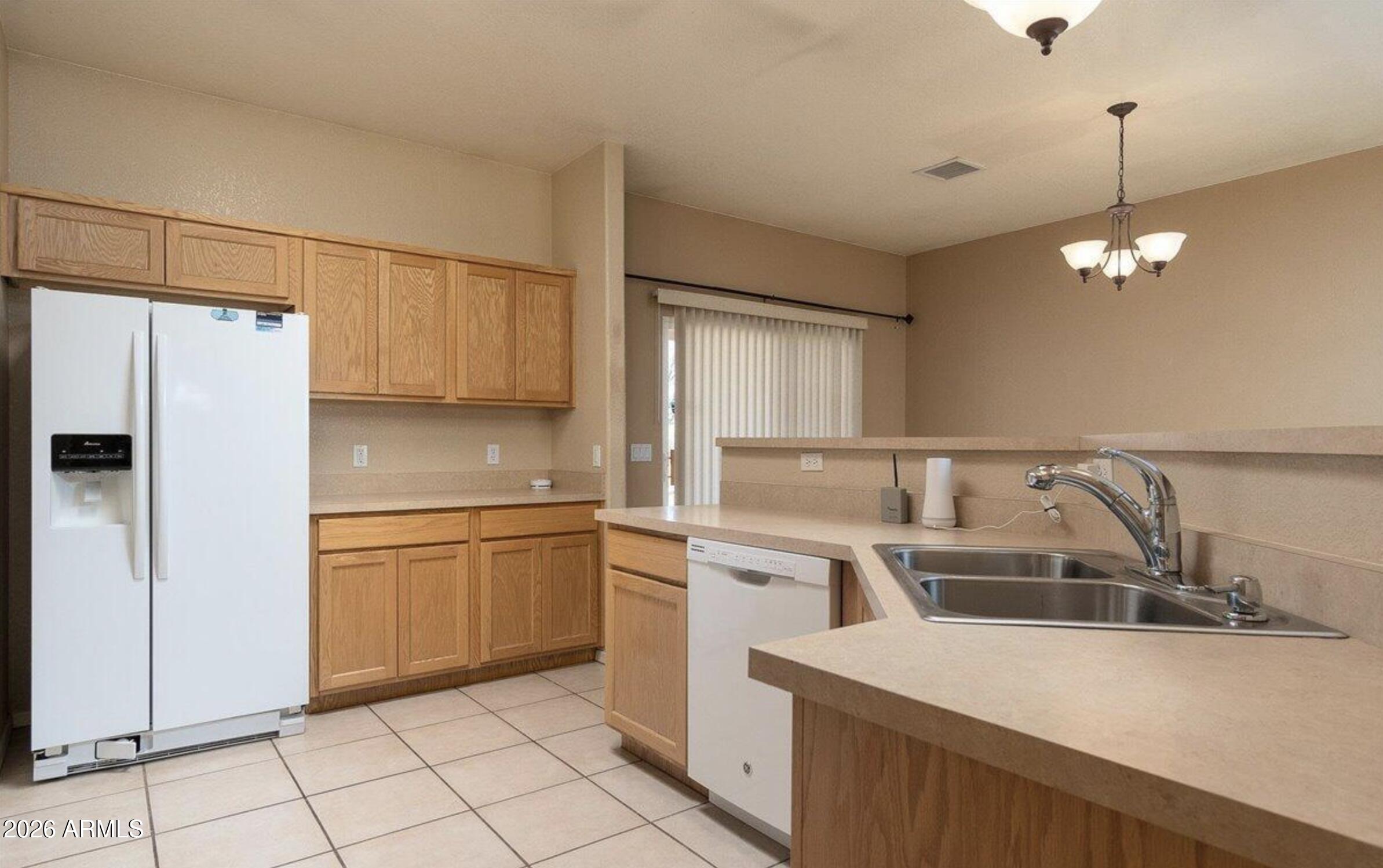 10193 East Windtalker Road Hereford, AZ 85615 - Photo 6 of 34 a kitchen with kitchen island granite countertop a sink cabinets and stainless steel appliances
