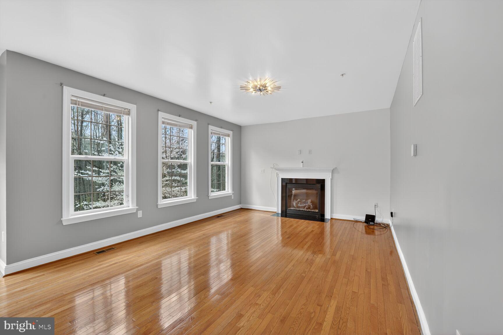 15900 Tanyard Road Upper Marlboro, MD 20772 - Photo 20 of 34 a view of an empty room with a fireplace and a window