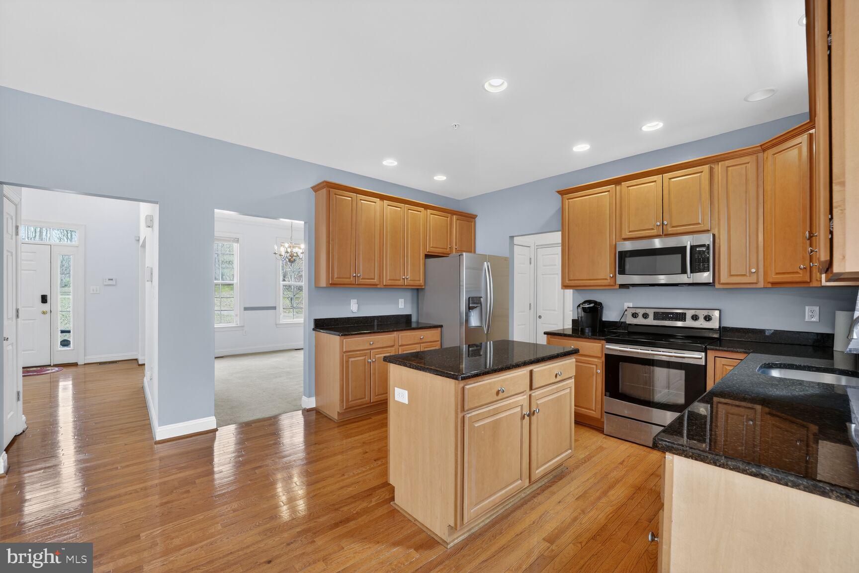 15900 Tanyard Road Upper Marlboro, MD 20772 - Photo 22 of 34 a kitchen with stainless steel appliances granite countertop a stove a sink and a refrigerator