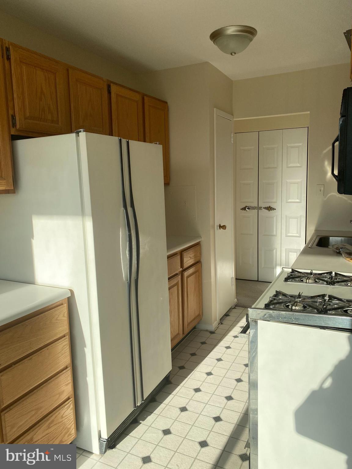 501 Slaters Lane, Unit 502 Alexandria, VA 22314 - Photo 19 of 24 Kitchen with white appliances