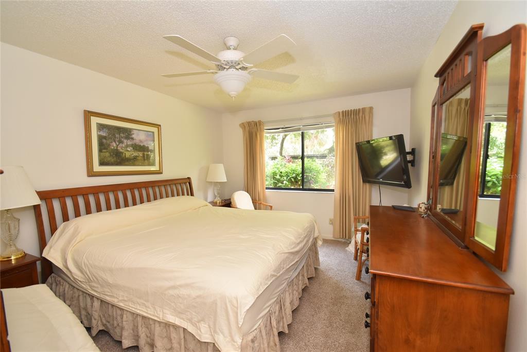 1709 Pelican Cove Road, Unit GL349 Sarasota, FL 34231 - Photo 14 of 29 a bed sitting in a bedroom next to a window