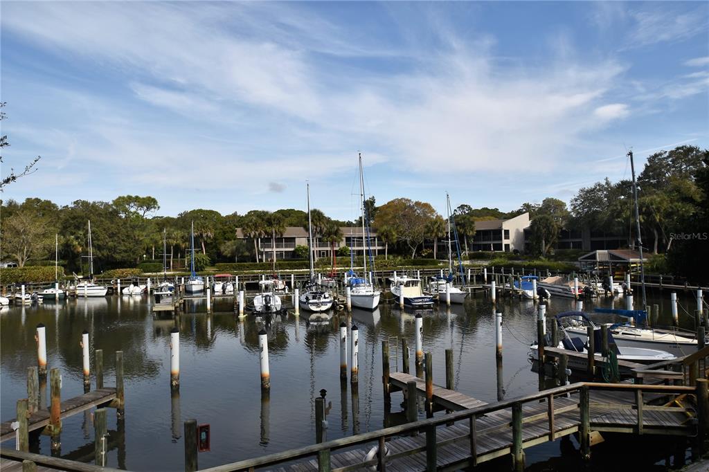 1709 Pelican Cove Road, Unit GL349 Sarasota, FL 34231 - Photo 22 of 29 a view of water with boats and trees in the background