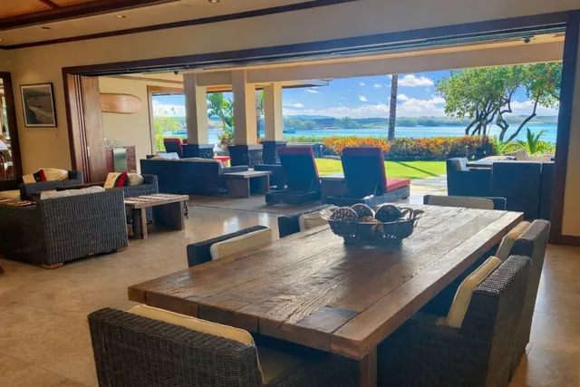 a dining room with furniture a large window and a table