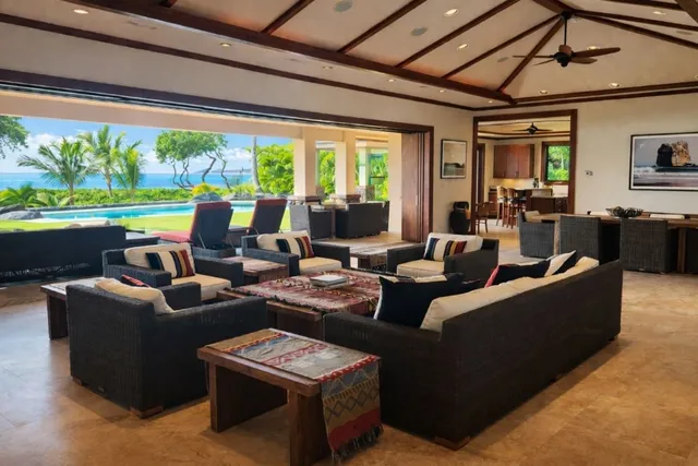 a living room with furniture and a floor to ceiling window