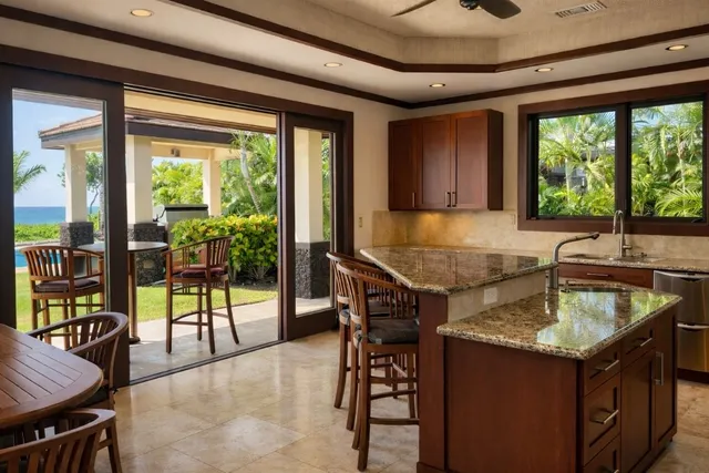 a kitchen with a stove a table and chairs in it