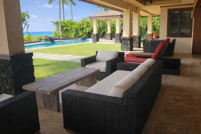 a view of swimming pool with outdoor seating and plants