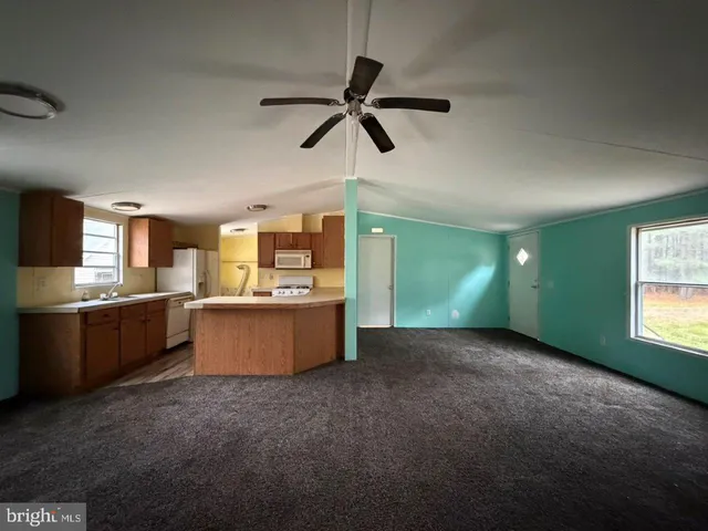 a large kitchen with kitchen island a sink stainless steel appliances and cabinets