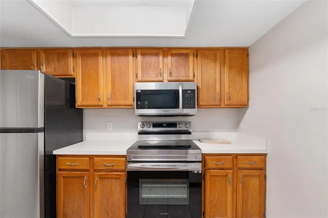 a kitchen with stainless steel appliances a stove and a refrigerator