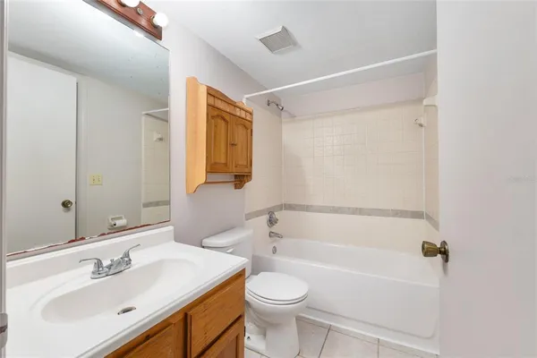 a bathroom with a sink mirror vanity and toilet