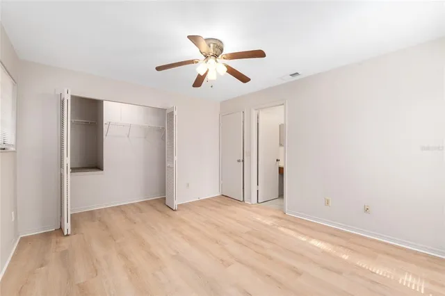 a view of empty room with ceiling fan