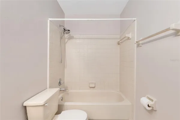 a bathroom with a toilet and a bathtub
