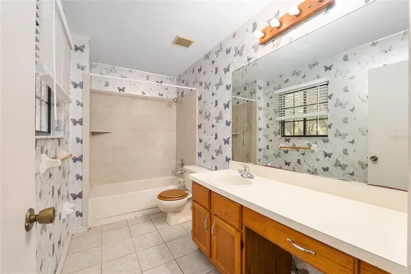 a bathroom with a bathtub shower sink mirror and toilet