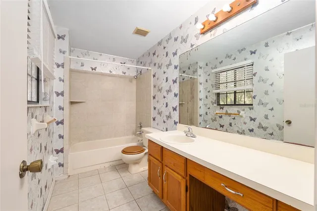 a bathroom with a bathtub shower sink mirror and toilet