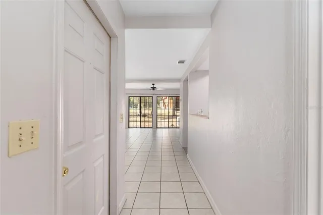 a view of a hallway with wooden floor and a window