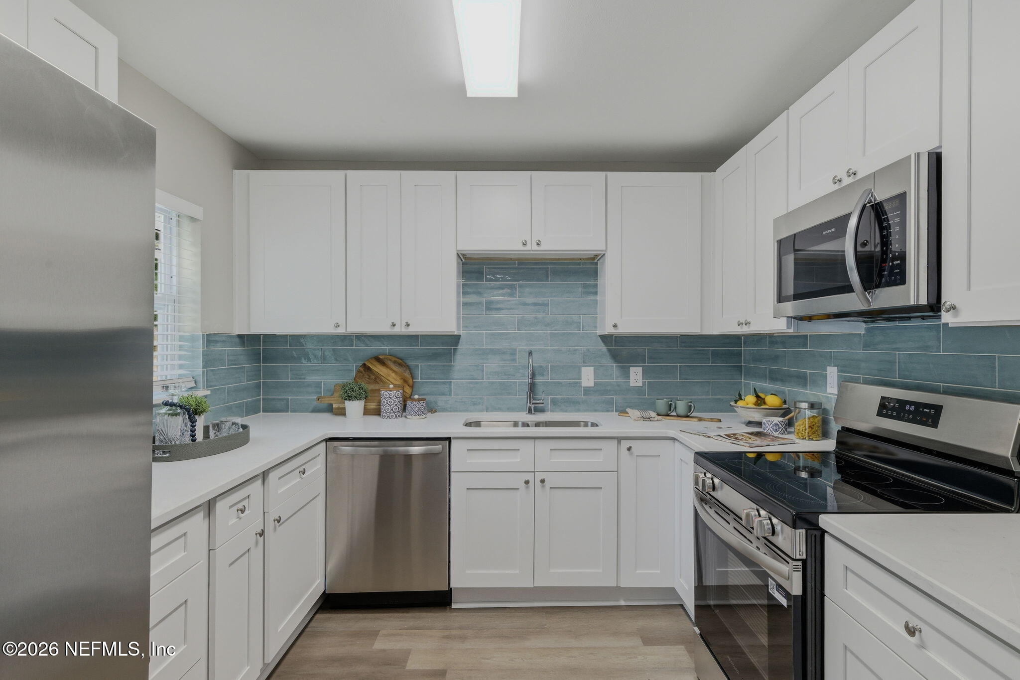 10184 Herndon Road Jacksonville, FL 32246 - Photo 13 of 28 a kitchen with stainless steel appliances granite countertop a sink stove and microwave