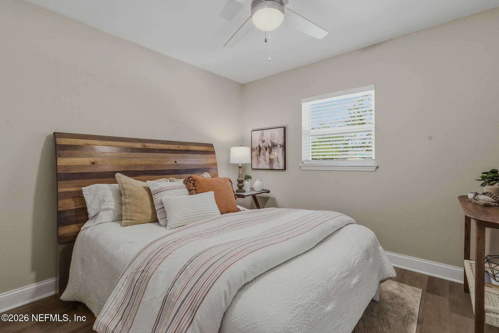 10184 Herndon Road Jacksonville, FL 32246 - Photo 17 of 28 a bedroom with a bed and a chandelier