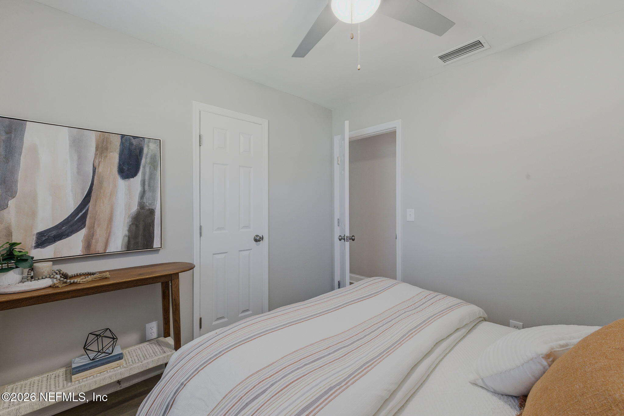 10184 Herndon Road Jacksonville, FL 32246 - Photo 18 of 28 a bedroom with a bed and a mirror