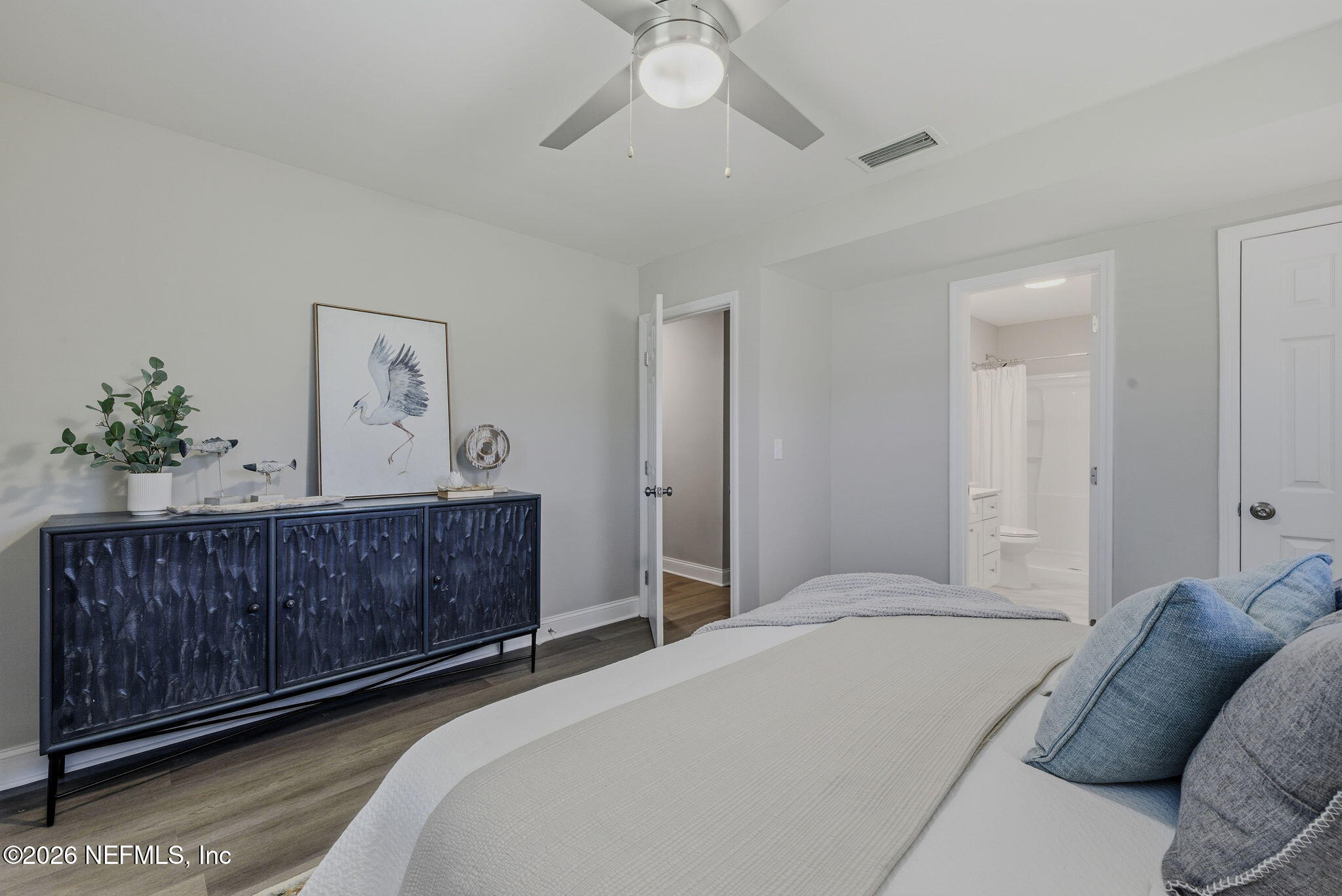 10184 Herndon Road Jacksonville, FL 32246 - Photo 21 of 28 a bedroom with a bed dresser and wooden floor