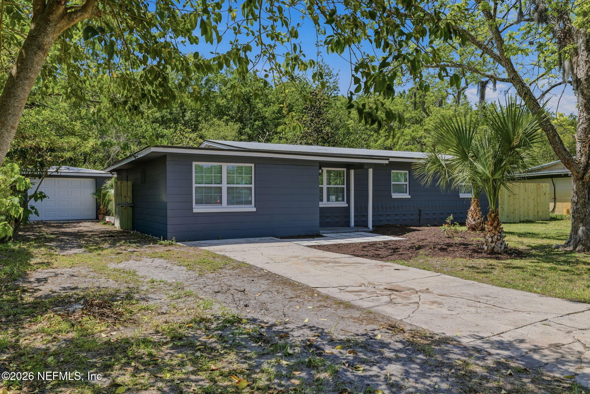 10184 Herndon Road Jacksonville, FL 32246 - Photo 27 of 28 a house with trees in the background