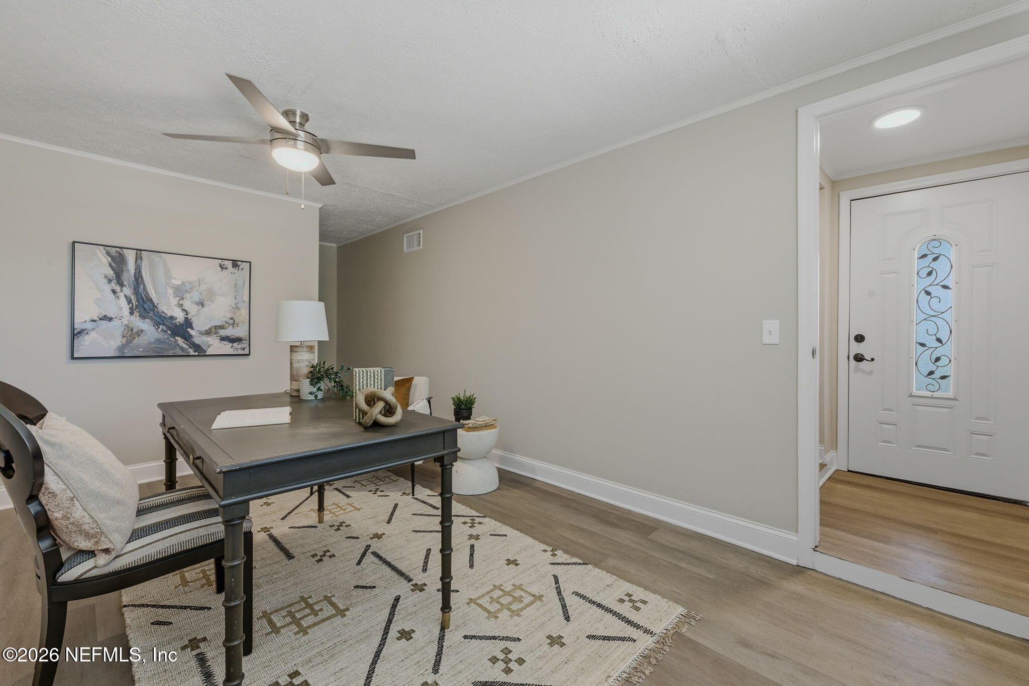 10184 Herndon Road Jacksonville, FL 32246 - Photo 3 of 28 a view of a workspace with furniture and wooden floor