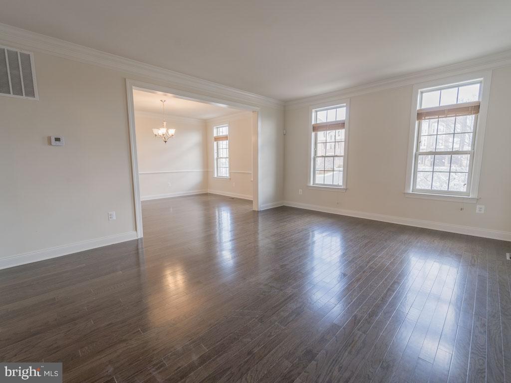 22595 Windsor Locks Square Ashburn, VA 20148 - Photo 37 of 56 an empty room with wooden floor and windows