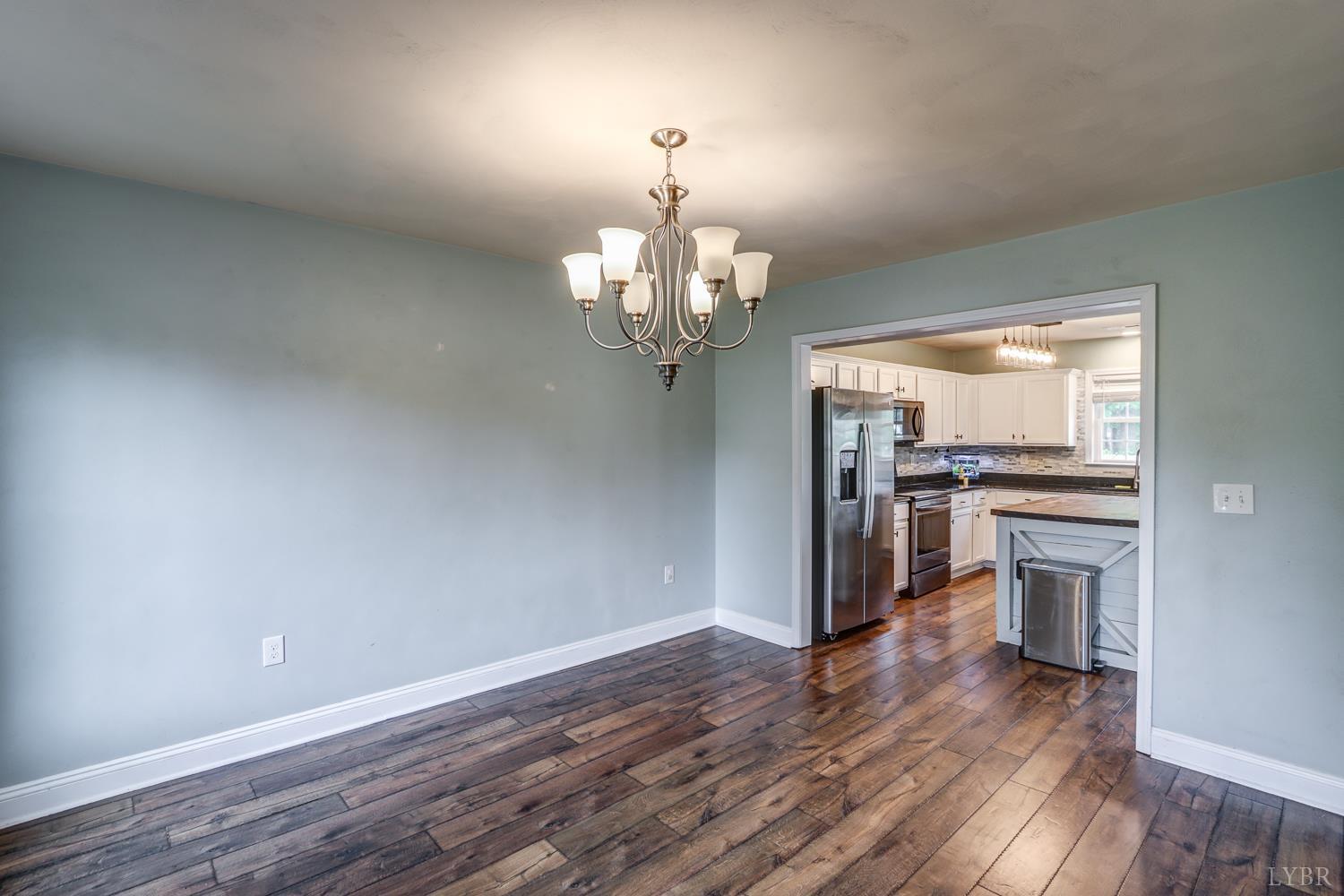 1057 Old Trail Road Forest, VA 24551 - Photo 20 of 49 a view of a kitchen with a dishwasher a kitchen island hardwood floor and a window
