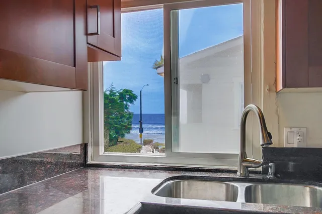 a large bedroom with two beds and a chandelier
