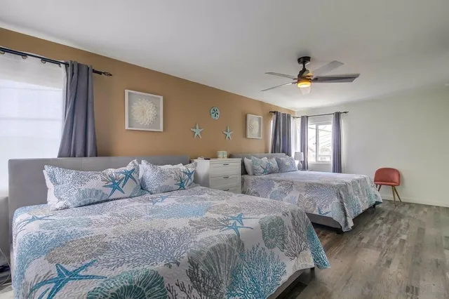 a spacious bedroom with two beds and a chandelier