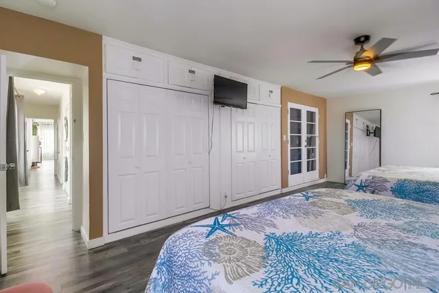 a bedroom with a large bed and a chandelier