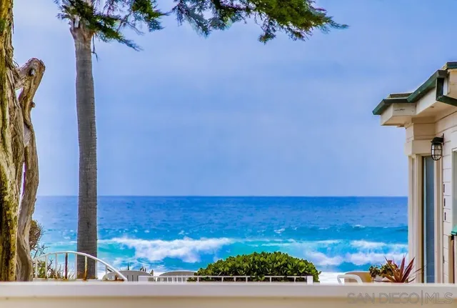 a view of a hallway with a livingroom and a bathroom with sink