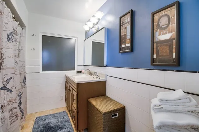 a bathroom with a sink toilet and a mirror