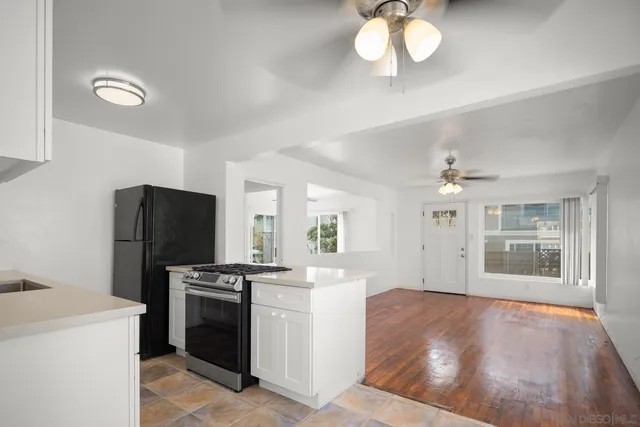 a kitchen with stainless steel appliances granite countertop a stove a refrigerator and a refrigerator