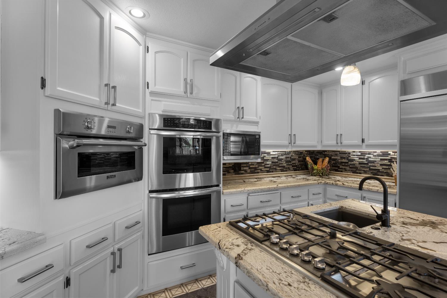 1801 Arroyo Drive Auburn, CA 95603 - Photo 19 of 68 a kitchen with refrigerator a stove and cabinets
