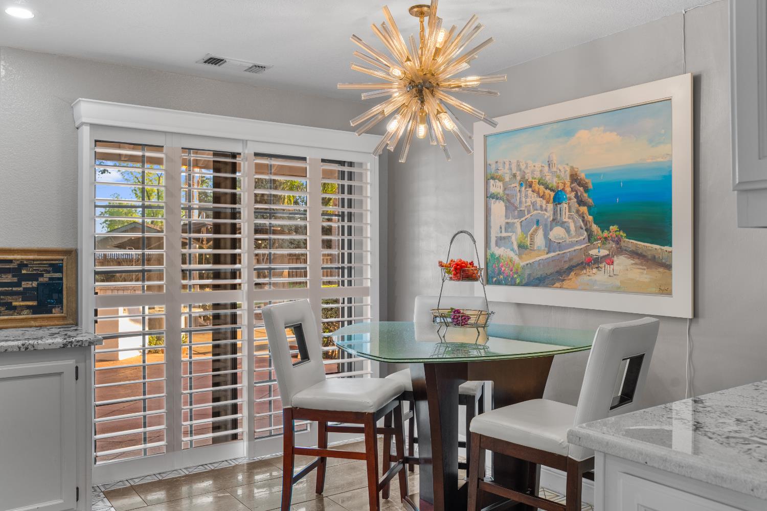 1801 Arroyo Drive Auburn, CA 95603 - Photo 20 of 68 a view of a dining room with furniture a chandelier and a flat screen tv