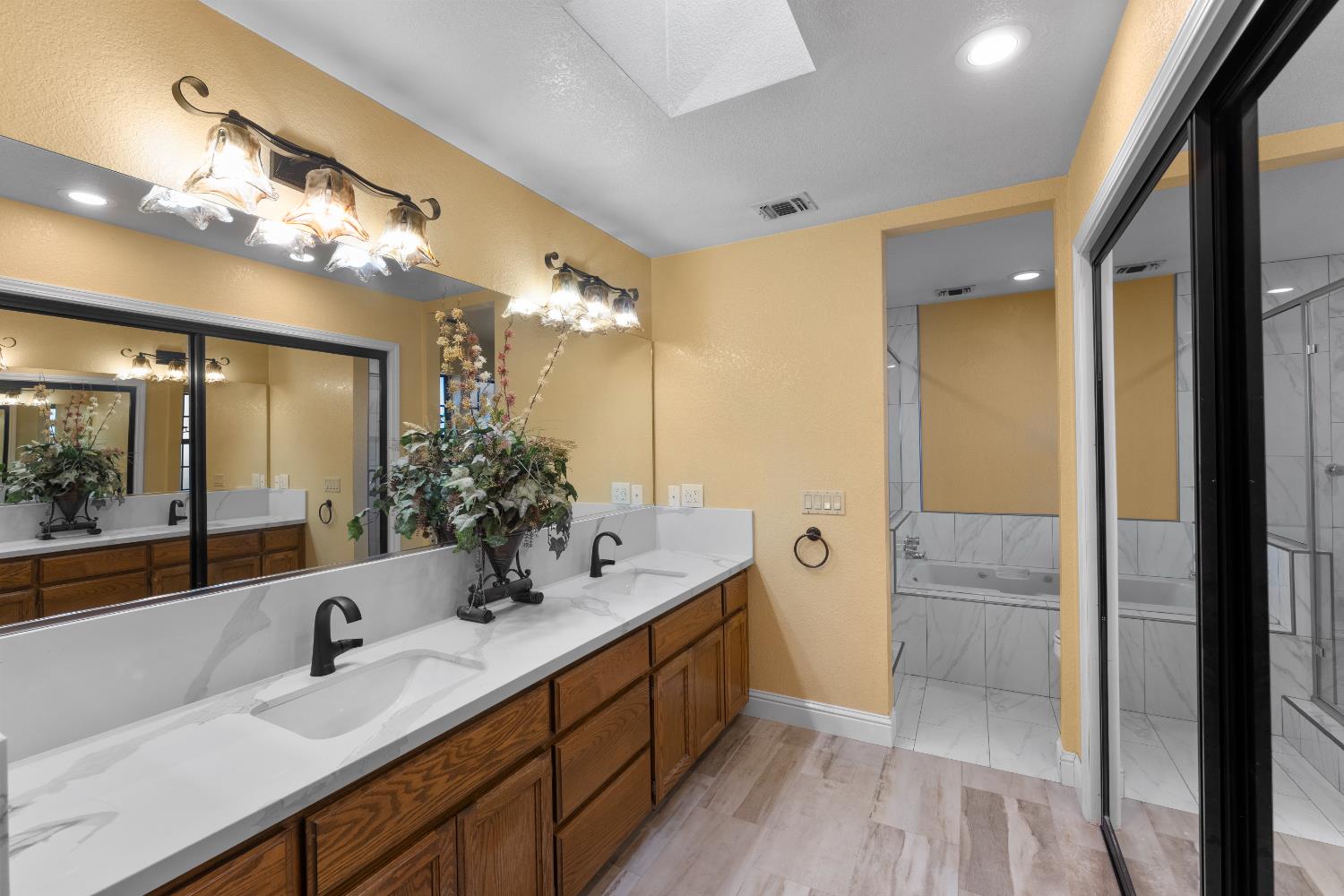 1801 Arroyo Drive Auburn, CA 95603 - Photo 29 of 68 a bathroom with a double vanity sink a mirror and a shower